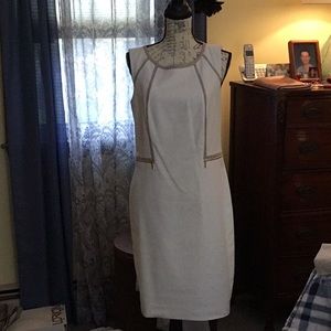 Calvin Klein off white with snake skin trim and matching zip up jacket.